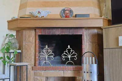 a fireplace with a wooden mantel with a fire place at La Coralline Pied dans l'eau, Vue apaisante in Casablanca