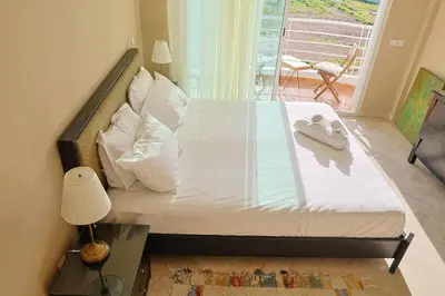 a bed with white sheets and pillows in a bedroom at La Coralline Pied dans l'eau, Vue apaisante in Casablanca