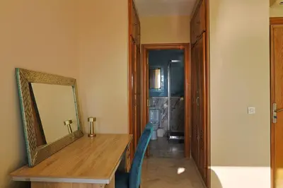 a hallway with a mirror and a wooden table at La Coralline Pied dans l'eau, Vue apaisante in Casablanca