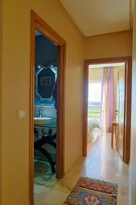 a bathroom with a mirror and a sink in a room at La Coralline Pied dans l'eau, Vue apaisante in Casablanca
