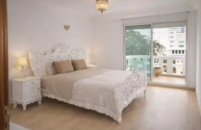 a white bedroom with a bed and a window at High Standing Apartment in Casablanca in Casablanca