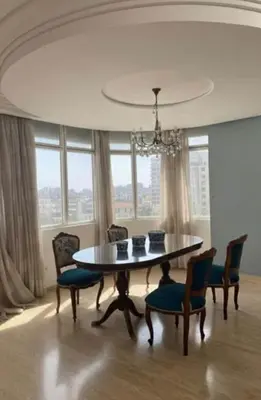 a dining room with a table and chairs and a chandelier at High Standing Apartment in Casablanca in Casablanca