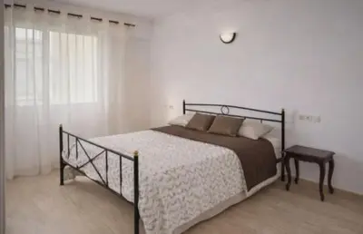 a bedroom with a bed and a table and a window at High Standing Apartment in Casablanca in Casablanca