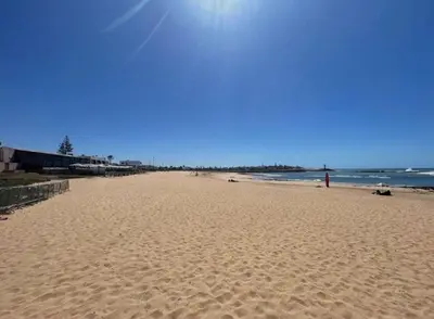 a sandy beach with the ocean in the background at Bungalow à 1 minute de la plage in Rabat