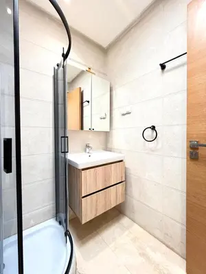 a bathroom with a sink and a shower at Bungalow à 1 minute de la plage in Rabat