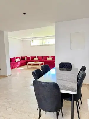 a dining room with a table and chairs at Bungalow à 1 minute de la plage in Rabat