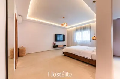 a bedroom with a bed and a television in it at Exceptional Private Room 1 SandRose in Casablanca