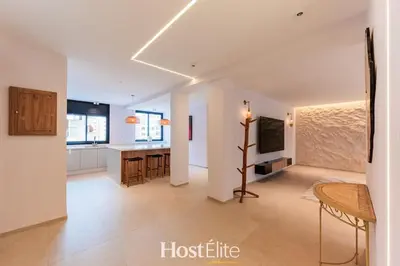 a living room with a table and a kitchen at Exceptional Private Room 1 SandRose in Casablanca