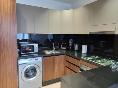 a kitchen with a washing machine and a sink at Elegance Comfort Terrace in the heart of Princesses in Maarif
