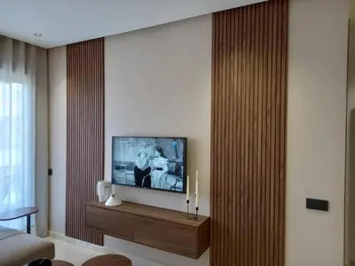 a living room with a flat screen tv on a wall at Elegance Comfort Terrace in the heart of Princesses in Maarif