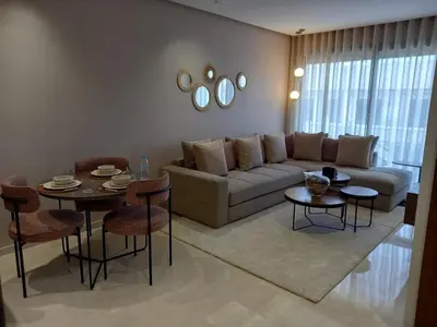 a living room with a couch and a table and chairs at Elegance Comfort Terrace in the heart of Princesses in Maarif