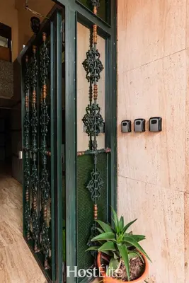 a window of a building with a plant in a pot at Exceptional Private Room 2 SandRose in Casablanca