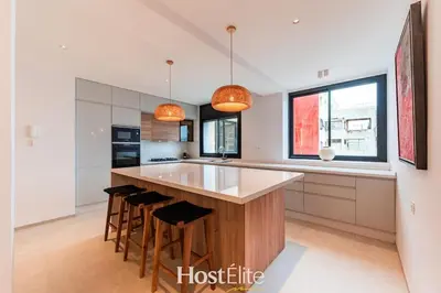 a kitchen with a large island with bar stools at Exceptional Private Room 2 SandRose in Casablanca