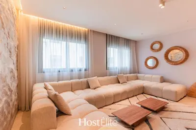 a living room with a large couch in front of a window at Exceptional Private Room 2 SandRose in Casablanca