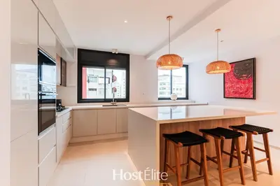 a kitchen with white cabinets and a counter with stools at Exceptional Private Room 2 SandRose in Casablanca