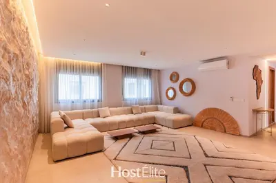 a large living room with a couch and a rug at Exceptional Private Room 2 SandRose in Casablanca