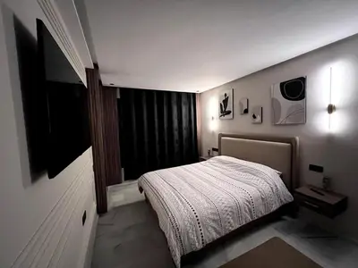 a small bedroom with a bed and a television at Apartment - Casablanca - Palmiers in Casablanca