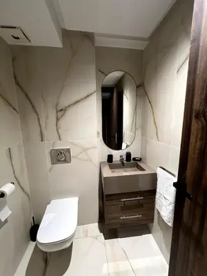 a bathroom with a sink and a mirror at Apartment - Casablanca - Palmiers in Casablanca
