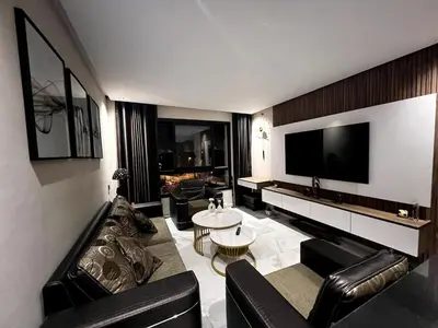 a living room with leather furniture and a flat screen tv at Apartment - Casablanca - Palmiers in Casablanca