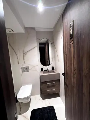 a bathroom with a sink and a toilet and a mirror at Apartment - Casablanca - Palmiers in Casablanca