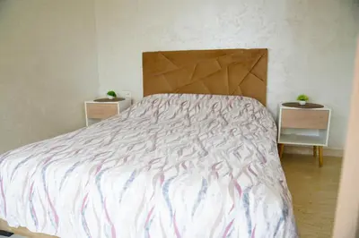 a bedroom with a bed with a striped bedspread at Contemporary Moroccan elegance in the heart of Casa in Casablanca