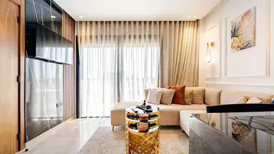 a living room with a couch and a table at Dynasty Estate Luxury Apartments in Palmiers, Casablanca in Maarif