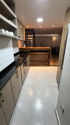 a large kitchen with white cabinets and a counter at Beautiful modern duplex - comfortable, good location in Casablanca