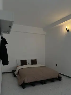 a bedroom with a bed in a white wall at Cozy getaway for a perfect stay in Rabat