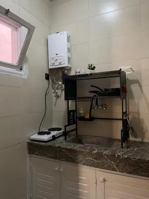 a kitchen counter with a sink and a microwave at Cozy getaway for a perfect stay in Rabat
