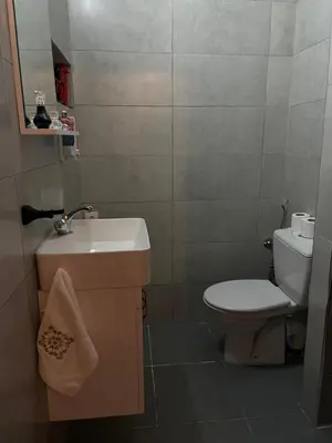 a small bathroom with a toilet and a sink at Cozy getaway for a perfect stay in Rabat