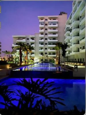 a building with a swimming pool in front of a building at Studio océan park in Casablanca