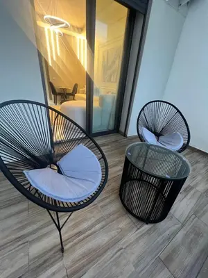 two chairs and a table in a room at Studio océan park in Casablanca
