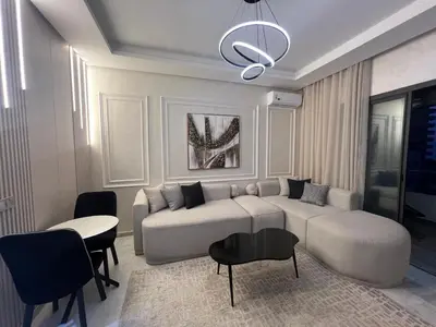 a living room with a couch and a table and chairs at Studio océan park in Casablanca