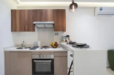 a kitchen with a sink and a stove top oven at Dynasty Estate Apartment Maarif with Parking Netflix Air Conditioning in Casablanca