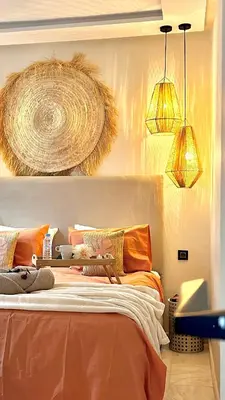 a bedroom with an orange bed with two lamps at The Art of Staying in Casablanca