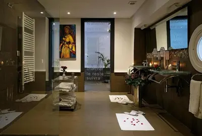 a bathroom with a sink and a counter with towels at Le Sphinx Boutique Hôtel in Mohammedia