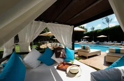 a patio with blue and white furniture and a pool at Le Sphinx Boutique Hôtel in Mohammedia