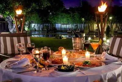a table with plates of food and glasses of wine at Le Sphinx Boutique Hôtel in Mohammedia