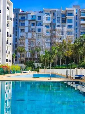 an empty swimming pool with buildings in the background at Appartment 2 BR de luxe in Rabat