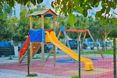 a playground with a slide in a park at Appartment 2 BR de luxe in Rabat