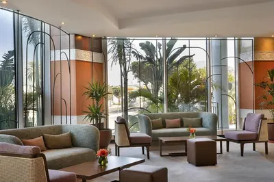 a lobby with couches and tables and windows at DoubleTree By Hilton Casablanca City Centre in Casablanca