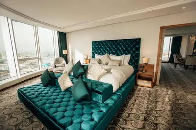 a hotel room with a large bed and a couch at DoubleTree By Hilton Casablanca City Centre in Casablanca