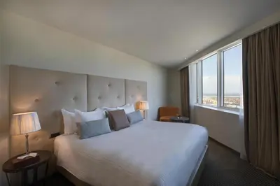 a hotel room with a large bed and a large window at DoubleTree By Hilton Casablanca City Centre in Casablanca