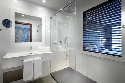 a white bathroom with a sink and a shower at Domo Casablanca in Casablanca