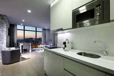 a kitchen with a sink and a living room at Domo Casablanca in Casablanca