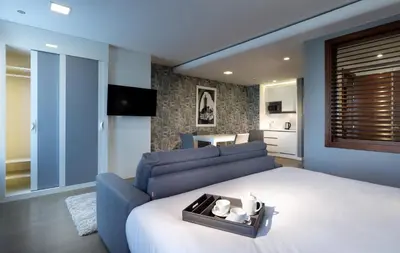 a bedroom with a large bed and a blue couch at Domo Casablanca in Casablanca