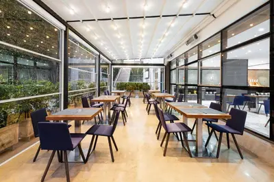 a restaurant with tables and chairs and windows at Domo Casablanca in Casablanca