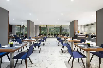 a restaurant with wooden tables and blue chairs at Domo Casablanca in Casablanca