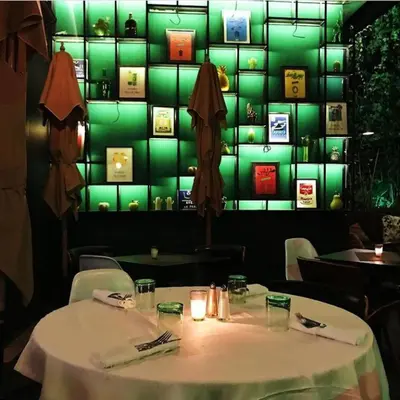 a table in a restaurant with a green wall at Boutique Hotel Gauthier Restaurant Terrasse in Casablanca