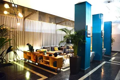 a lobby with couches and potted plants in a building at Boutique Hotel Gauthier Restaurant Terrasse in Casablanca